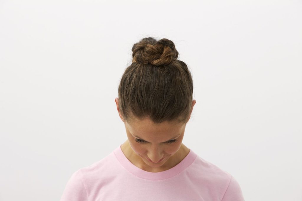 woman-with-head-down-showing-hair-bun-awaken