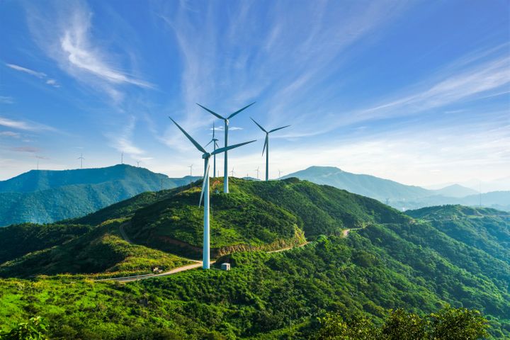 Wind turbines in Zhejiang province, China. In many places wind and solar power are already cheaper than fossil fuels.
