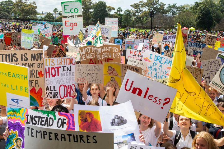 Thousands gathered in Sydney, many bearing signs decrying the government's support of fossil fuel and inaction on climate cha