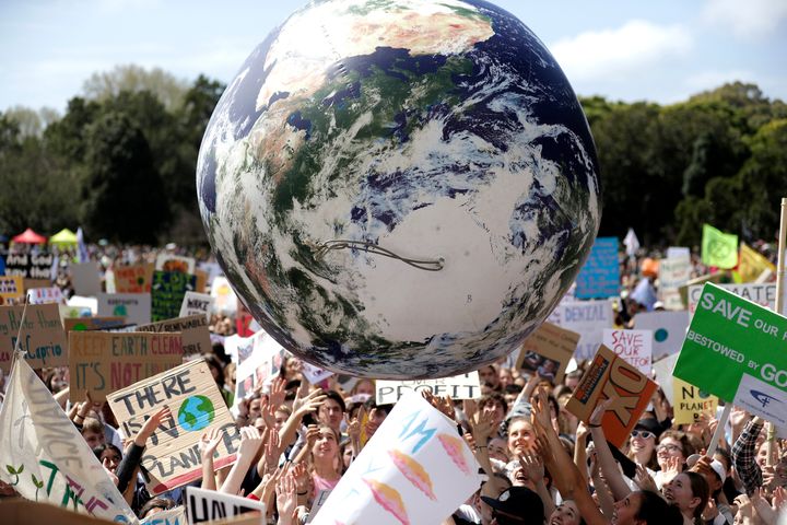A large inflatable globe is bounced through the crowd as thousands of protestors, many of them students, gather in Sydney, Fr