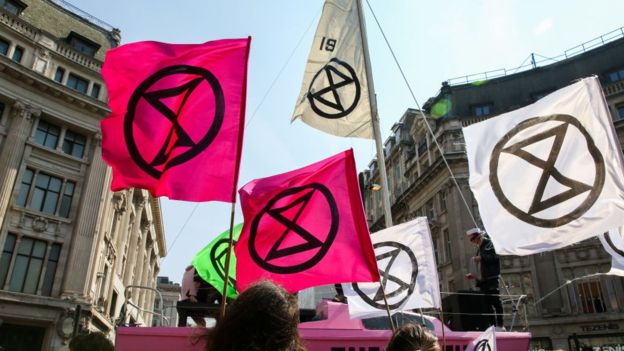 Extinction Rebellion flags with the hourglass logo