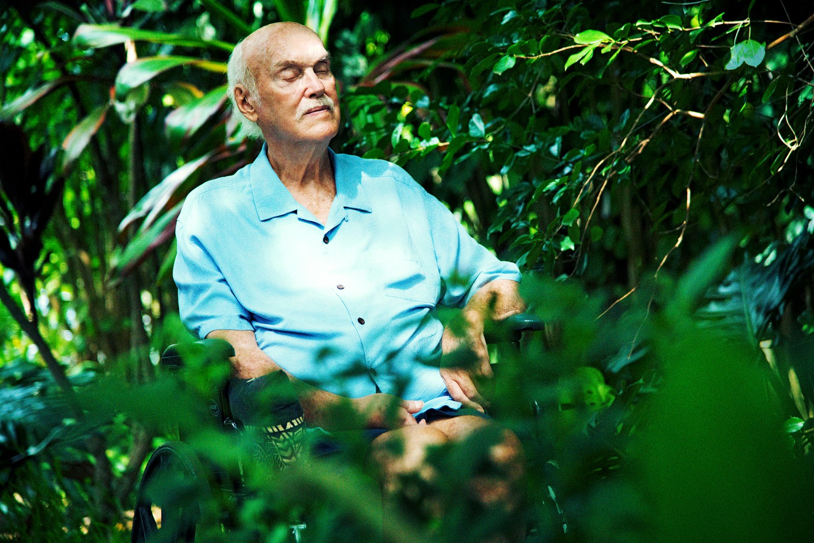 Ram Dass closing his eyes among trees.