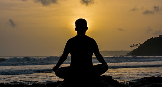 silhouette-of-man-meditating-on-beach-awaken