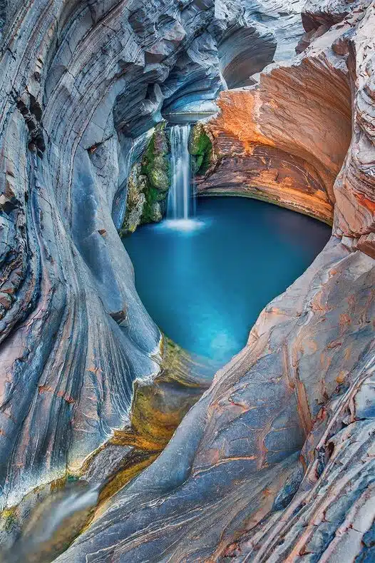 The striking rock formations and beautiful pool of Harmersley Gorge in Karijini National Park, Western Australia.-awaken