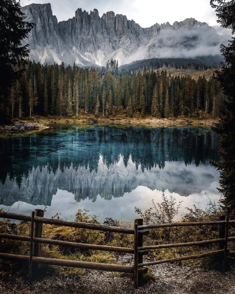 Lake Carezza (Italian: Lago di Carezza; German: Karersee) is a small alpine lake in the Dolomites in South Tyrol, Italy-awaken