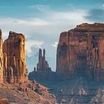 A scenic road in the Arizona desert leading to tall rock formations.-awaken