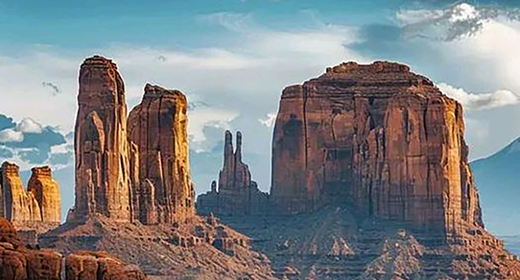 A scenic road in the Arizona desert leading to tall rock formations.-awaken