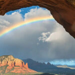 The Beautiful rainbow over Sedona, Arizona, taken from inside an arch rock formation.-awaken