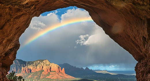 The Beautiful rainbow over Sedona, Arizona, taken from inside an arch rock formation.-awaken